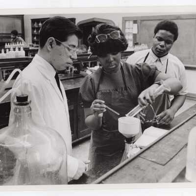 Tony Naddeo, graduate assistant, in science laboratory with several high school students participating in Chemistry Department's Science Motivation Program for high school students, May 1969.