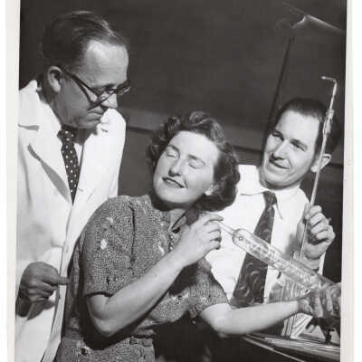 View of three biology professors in science laboratory, including Catherine Nash, c. 1952.