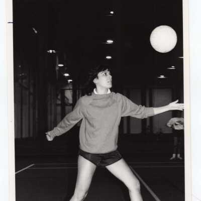 Women's volleyball player serving.