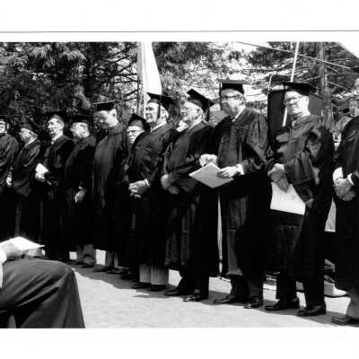 View of group of alumni, possibly Golden Hawks during graduation/commencement, c. 1984.
