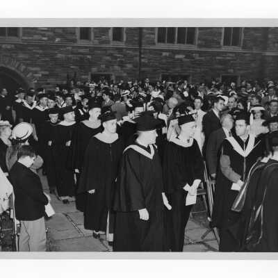 Students and faculty processing into Barbelin quadrangle during 1947 graduation/commencement ceremony.