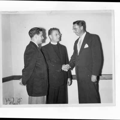 Edward G. Jacklin, S.J., and alumni officers, William Ariano and Paul E. Kelly, launch Fifth Annual Giving drive, February 28, 1954.