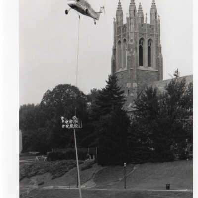Helicopter hoisting new lights on Finnesey Field.