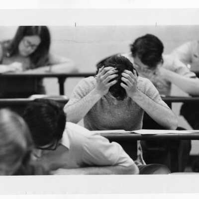 Students taking exam in classroom.