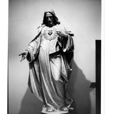 Interior view of hallway in Barbelin with statue of Jesus.