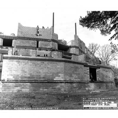 View of McShain Hall construction with workmen.
