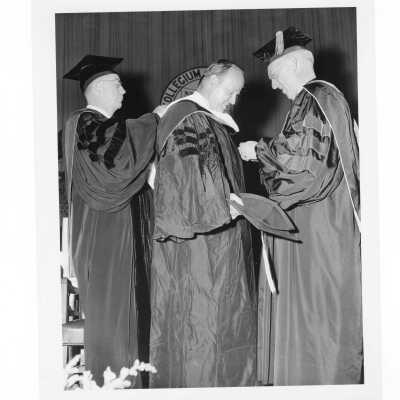 J. Joseph Bluett, S.J., conferring honorary degree to Augustus Long during 1961 graduation/commencement.