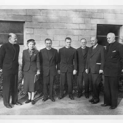 Photo of individuals-- Paul Reinert, S.J., Dr. and Mrs. W.F. Russell, Edward Gannon, S.J., Edward Jacklin, S.J. Allan Farrell, S.J. Hunter Guthrie,S.J.-- attending symposium on Jesuit education as part of centennial celebration, October 27, 1951.