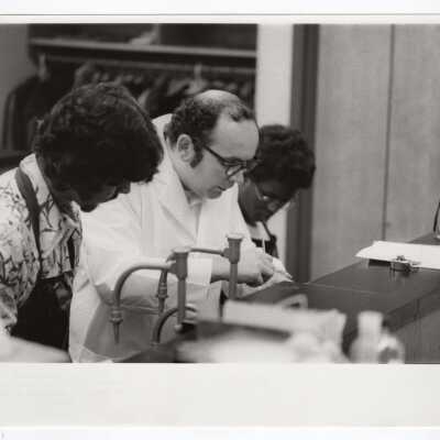 SJC chemistry professor working with a high school student in laboratory as part of Chemistry Department's Science Motivation Program, c. 1972.