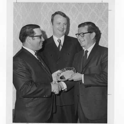 Richard J. Hughes receiving Law Alumni Award with two other individuals watching, December 2, 1969.