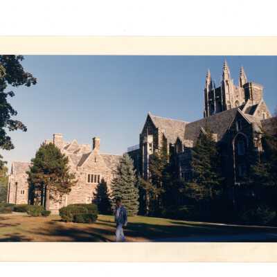 Exterior side view of Barbelin with student walking.