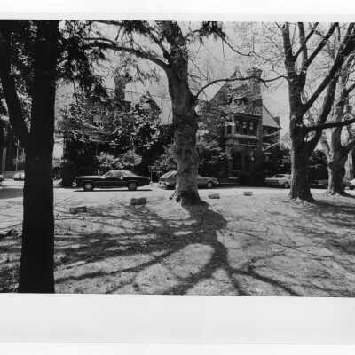 Exterior view of Wolfington Center (formerly Gest Estate, Neumann Hall) with cars parked in front.