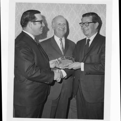Richard J. Hughes receiving Law Alumni Award with two other individuals watching, December 2, 1969.