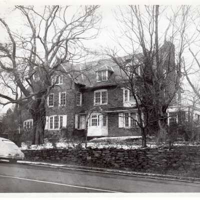 Exterior view of Greaton Hall from Cardinal Avenue with car parked on street.