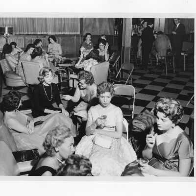 View of women taking break during alumni association dance, November 27, 1959.
