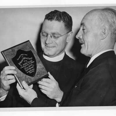 Edward G. Jacklin, S.J. holding trophy won by Villiger Debating team in international debate with Oxford.