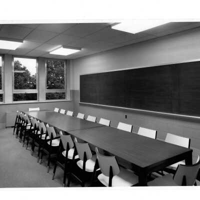 View of long conference tables in classroom of Villiger (later Post) Academy of Food Marketing.