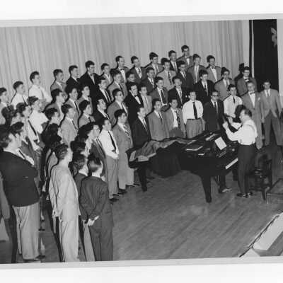 Members of Glee Club performing under direction Herbert Fisk.