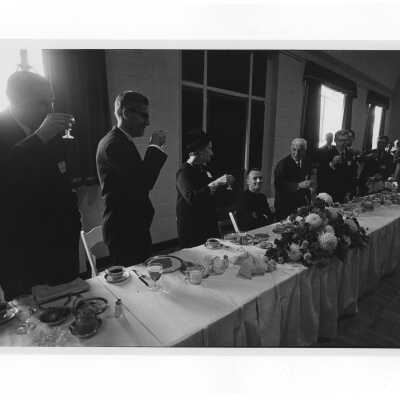 Inauguration of President Terrence Toland, S.J., November 14, 1968. Guests raise glasses in toast to President Toland at luncheon in Flanigan Auditorium.