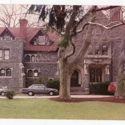 View of front of Wolfington Center (formerly Gest Estate, Neumann Hall) with parked cars.