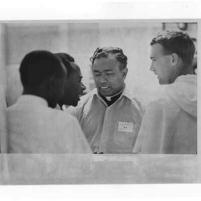 Pax Romana's 20th World Plenary Assembly meets at Saint Joseph's College, August 1968. View of attendees taking a break in the Field House lobby.