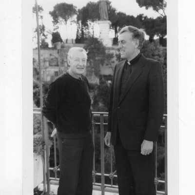 Donald I. MacLean, S.J., standing with another individual in Italy?