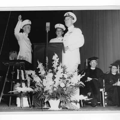 Graduating student, Gordon Shockley, being commissioned in Marine Corps by his father, Lt. Commander Lawrence Shockley during 1955 graduation/commencement.