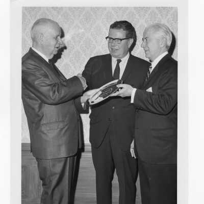 Charles A. Waters holding Law Alumni Award with others watching, November 28, 1967.