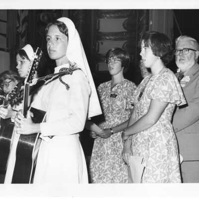 View of musicians and James E. Dougherty participating in International Eucharistic Congress, symposium on hunger, August 2, 1976, held at Philadelphia Civic Center.