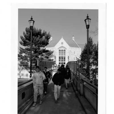 Students walking on pedestrian bridge from McShain Hall.