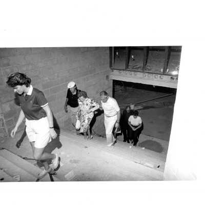 View of Mary McShain and others visiting construction site of McShain Hall.