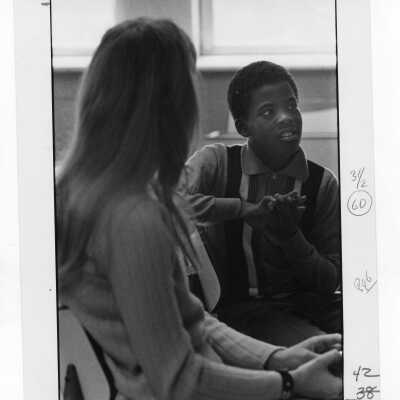 Student tutoring child at Rhoads Public School (?) as part of community service/outreach project. (Peace and Human Development program?)