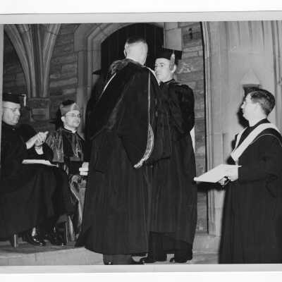 Honorary degree being awarded to Judge Vincent A. Carroll by John J. Long, S.J. during 1947 graduation/commencement ceremony. Other in photograph include: Bishop Carroll McCormick, Father Drane, and Dr. Distler.