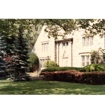 View of front of Regis Hall in spring.