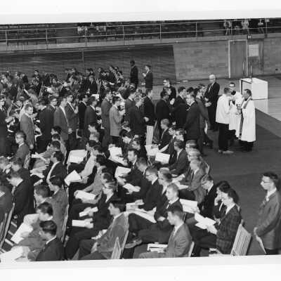 Students receiving communion during Mass of the Holy Spirit in Field House, October 8, 1963.
