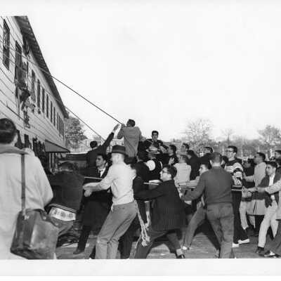 Students and Hawk mascot pulling down Cardboard College also known as Barbelin Annex.