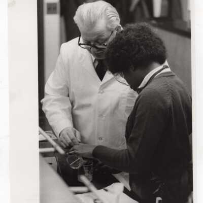George Beichl, SJC chemistry professor, working with a high school student in laboratory as part of Chemistry Department's Science Motivation Program, c. 1972.