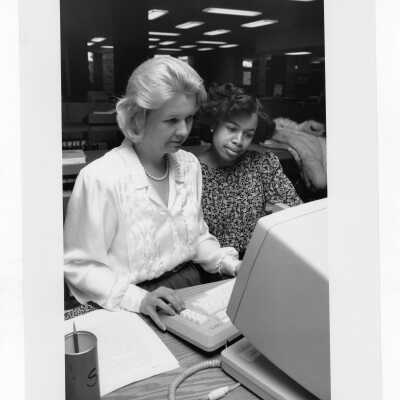 Student with Ene Andrilli at computer terminal in Drexel Library.