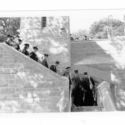 Graduating students processing down steps of McShain pedestrian bridge to Gest Lawn for 1993 graduation/commencement ceremony.