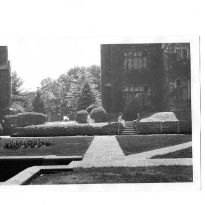 Two students sitting in wall in Barbelin quadrangle.