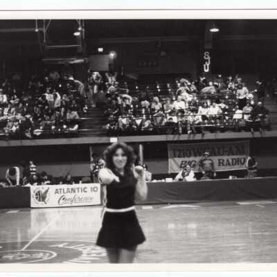 Woman cheerleader at basketball game.