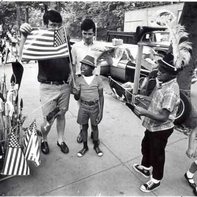 Students from "The House" or SJC Commune at 17th and Girard Streets, Philadelphia, with neighborhood children at street fair.