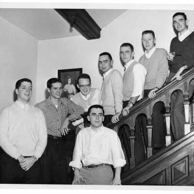 Student residents of Quirk Hall standing on stairway.