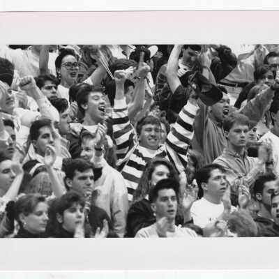 Students cheering at basketball game.