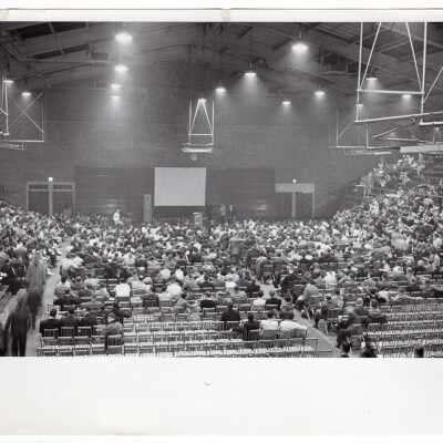 View of closed circuit telecast and audience in Field House broadcasting game in 1960 NCAA basketball tournament in Charlotte, North Carolina.