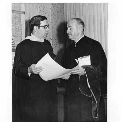 Honorary degree recipient Governor William T. Cahill standing with other individual during 1970 graduation/commencement.