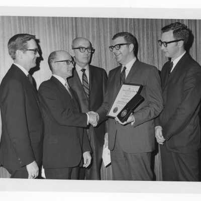 Shaffrey award recipient, Dr. Joseph T. English, showing medal and certificate to four others, April 9, 1969.