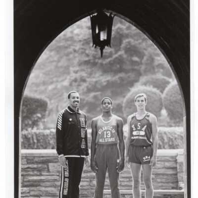 Men's Basketball- three players in Barbelin Hall arch