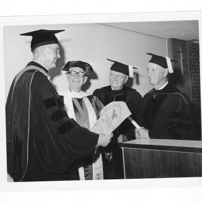 William F. Maloney, S.J., with three honorary degree recipients, Bishop Fred Pierce Corson, Hubert J. Horan, Jr., and Philip H. Cooney during October 1963 graduation/commencement.