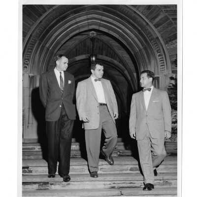Members of alumni homecoming planning committee--Dick Carroll, Robert, Lombardi, and William Ariano-- standing in Barbelin archway, June 2, 1955.
